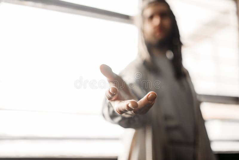 Jesus Christ in white robe reaching out his hand. Window with sunlight on background. Son of God, christian faith symbol royalty free stock photos