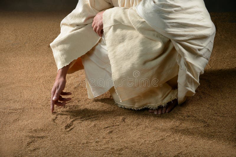Jesus som skriver i sanden arkivfoto Jesus som skriver i sanden arkivfoto