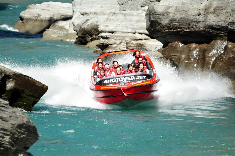 QUEENSTOWN,NZ - FEB 20: Tourists enjoy a high speed jet boat ride on the Shotover River on February 20, 2009 in Queenstown, New Zealand. Queenstown is one of the most popular summer resort in NZ. QUEENSTOWN,NZ - FEB 20: Tourists enjoy a high speed jet boat ride on the Shotover River on February 20, 2009 in Queenstown, New Zealand. Queenstown is one of the most popular summer resort in NZ.