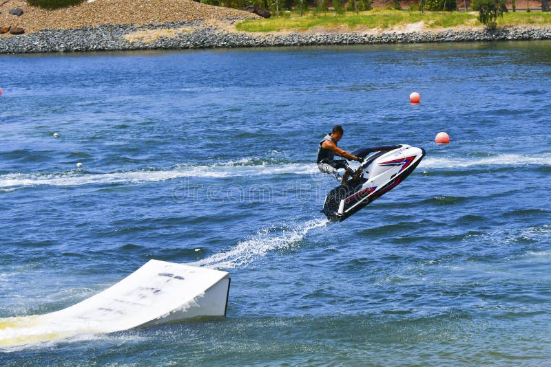 Jet Ski jumping over ramp stock photo. Image of sports 84889080