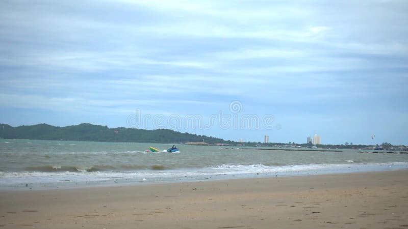 Jetski is pulling a Banana Boat in Rayong Beach Thailand