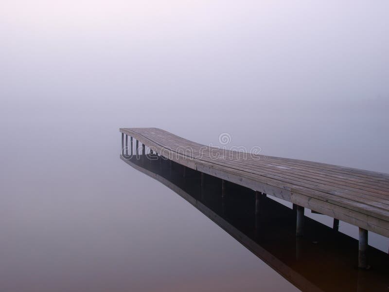 Jetty at a lake in foggy morning