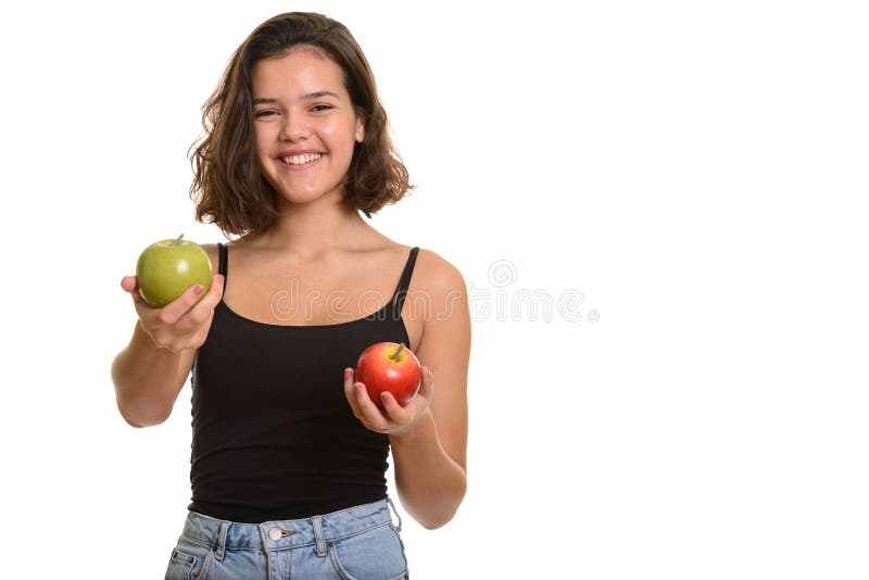 Jeune adolescente caucasienne heureuse souriant tenant la pomme rouge et images stock Jeune adolescente caucasienne heureuse souriant tenant la pomme rouge et images stock