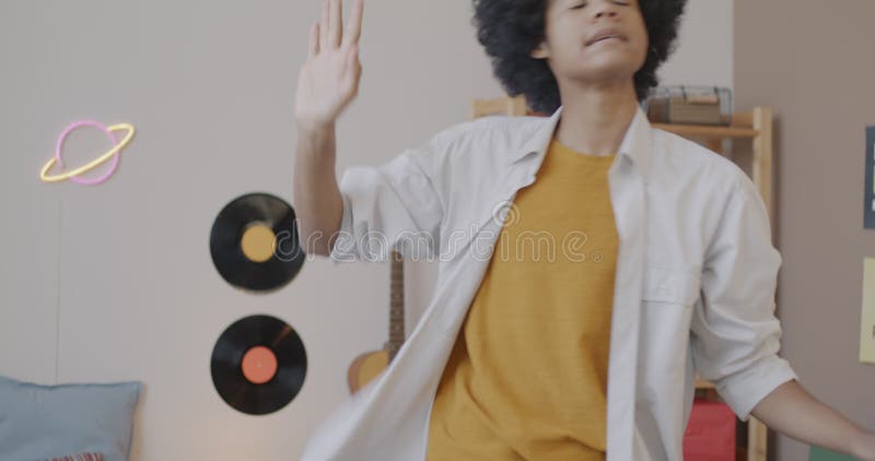 Jeune afro-américain heureux danser sur la musique déménager profiter du temps libre à la maison clips vidéos