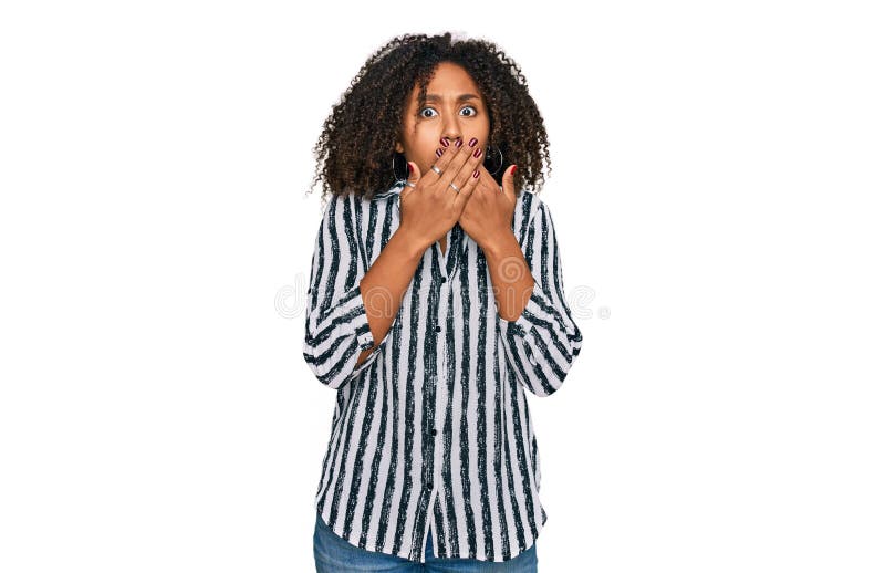 Jeune afro-américaine portant des vêtements décontractés qui se couvrent la bouche avec les mains pour l'erreur photos libres de droits