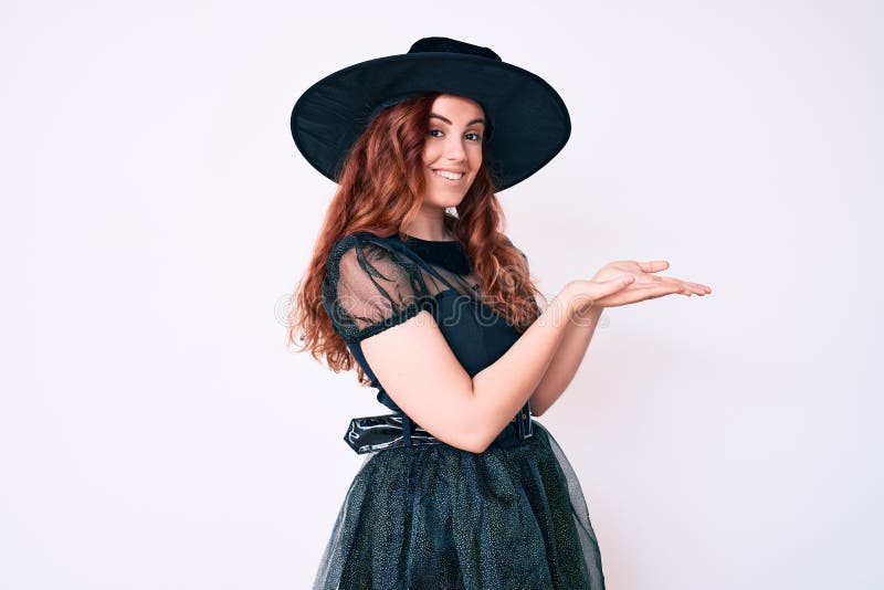 Young beautiful woman wearing witch halloween costume pointing aside with hands open palms showing copy space, presenting advertisement smiling excited happy. Young beautiful woman wearing witch halloween costume pointing aside with hands open palms showing copy space, presenting advertisement smiling excited happy