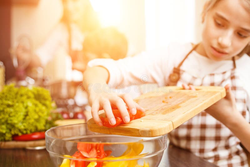 Jeune cuisinière d'adolescente ainsi que sa famille images libres de droits Jeune cuisinière d'adolescente ainsi que sa famille images libres de droits