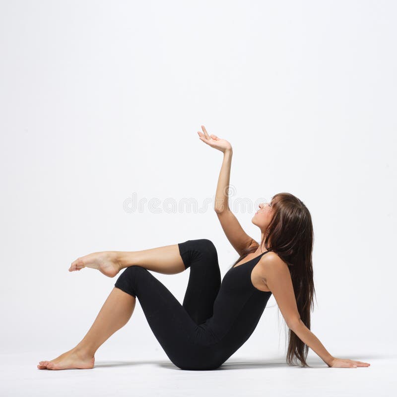 Jeune danseuse de ballet moderne dansant sur fond studio gris