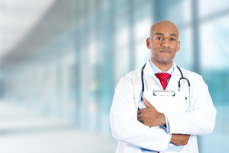 Jeune docteur sûr heureux se tenant dans le couloir d'hôpital photo libre de droits Jeune docteur sûr heureux se tenant dans le couloir d'hôpital photo libre de droits