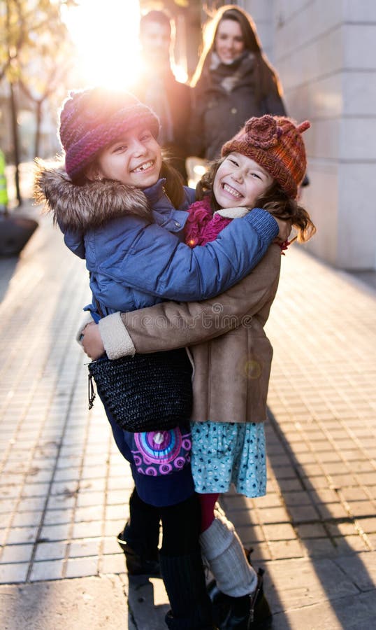 Jeune famille heureuse ayant l'amusement dans la rue image stock Jeune famille heureuse ayant l'amusement dans la rue image stock