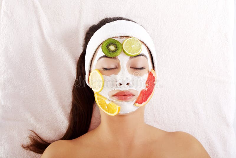 Beautiful young woman with fruit mask on a face. Beautiful young woman with fruit mask on a face