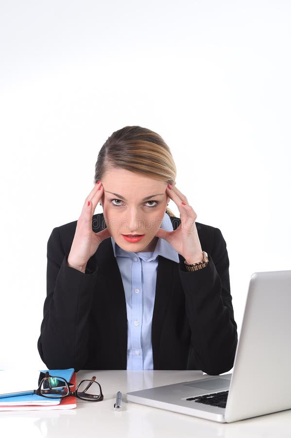 Young attractive businesswoman working on office computer laptop sitting at office frustrated, overworked suffering stress, headache, depression and work problems. Young attractive businesswoman working on office computer laptop sitting at office frustrated, overworked suffering stress, headache, depression and work problems