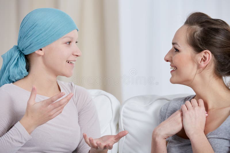 Young cancer women wearing headscarf, talking with friend. Young cancer women wearing headscarf, talking with friend