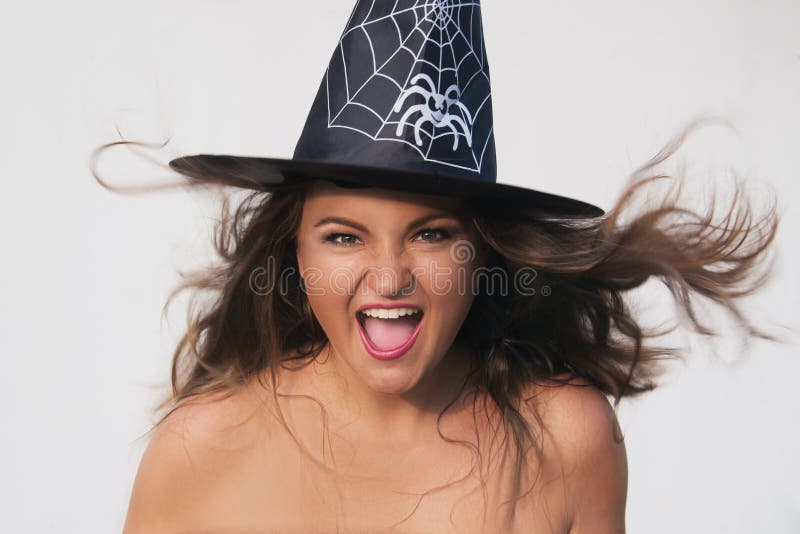 Excited young woman in Halloween witch hat on white background. Excited young woman in Halloween witch hat on white background