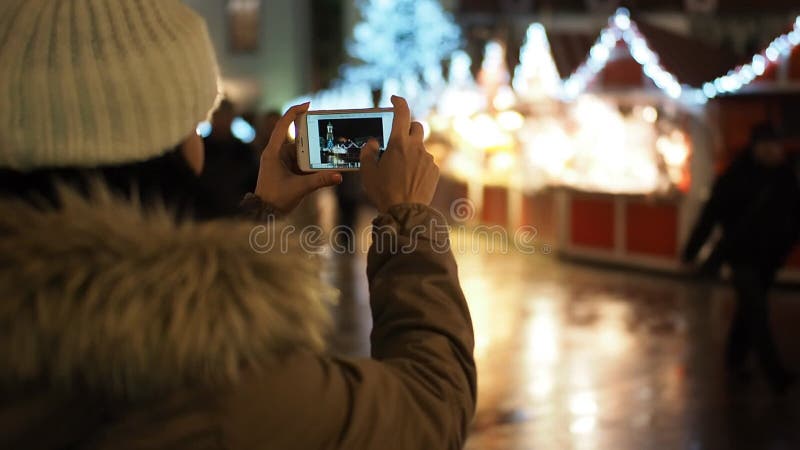 Jeune femme faisant l'image avec le portable sur la rue d'hiver clips vidéos