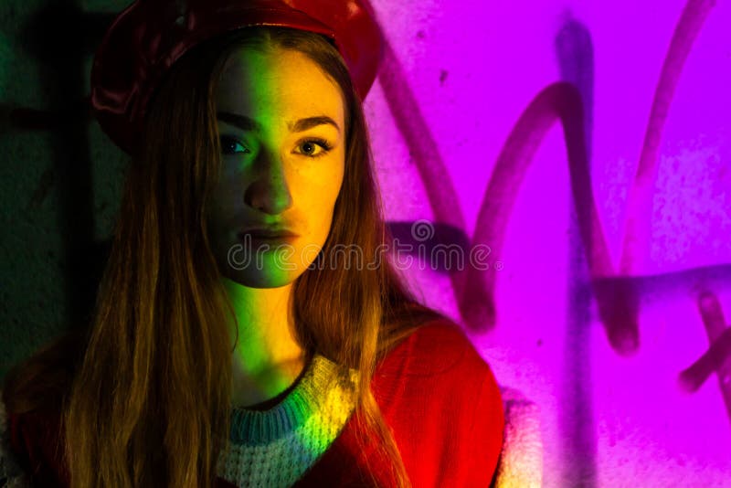 French clothing style, street fashion. A beautiful girl in a coat, red beret in old city. Autumn mood and vibes. young woman tourist with light makeup looks around standing near bar with colorful neon sign against night megalopolis. French clothing style, street fashion. A beautiful girl in a coat, red beret in old city. Autumn mood and vibes. young woman tourist with light makeup looks around standing near bar with colorful neon sign against night megalopolis.