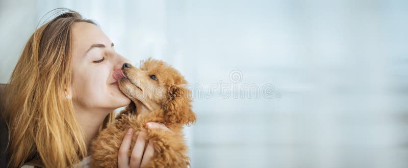 Young girl kissing her good friend dog . Background. Young girl kissing her good friend dog . Background.