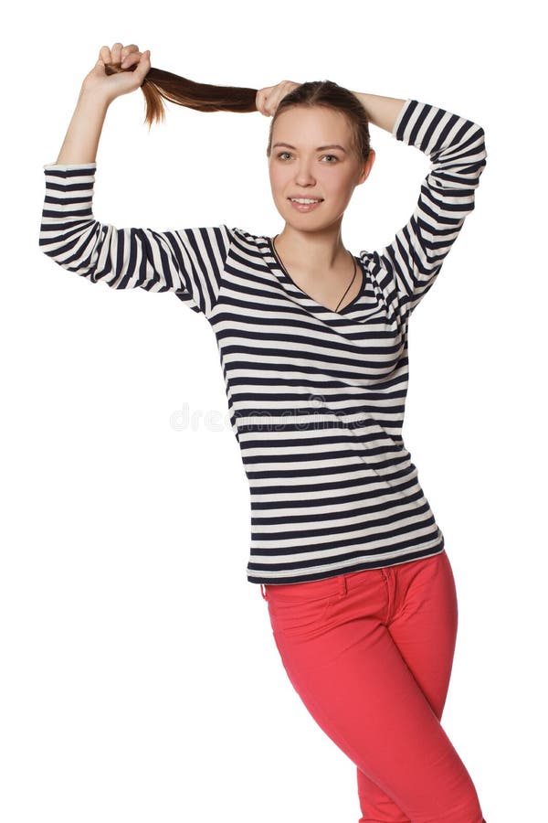 Jeune fille tenant des cheveux et le sourire images libres de droits Jeune fille tenant des cheveux et le sourire images libres de droits