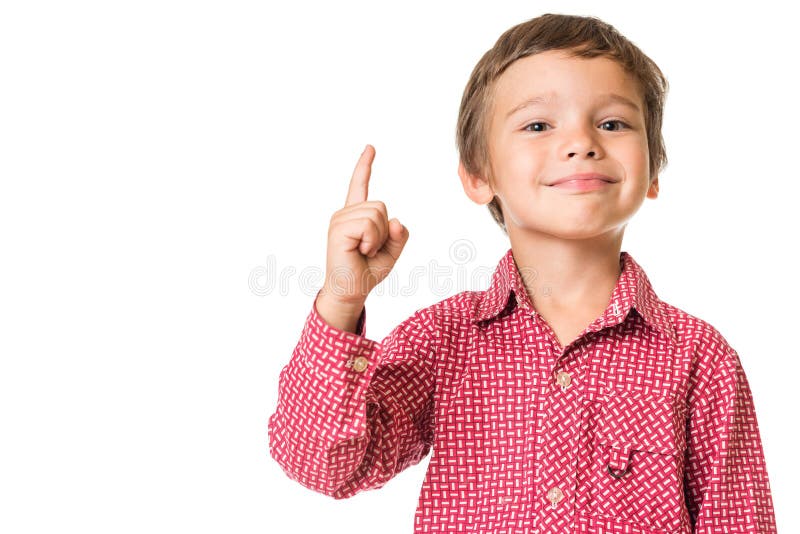 Jeune garçon souriant et dirigeant le doigt vers le haut photo stock Jeune garçon souriant et dirigeant le doigt vers le haut photo stock