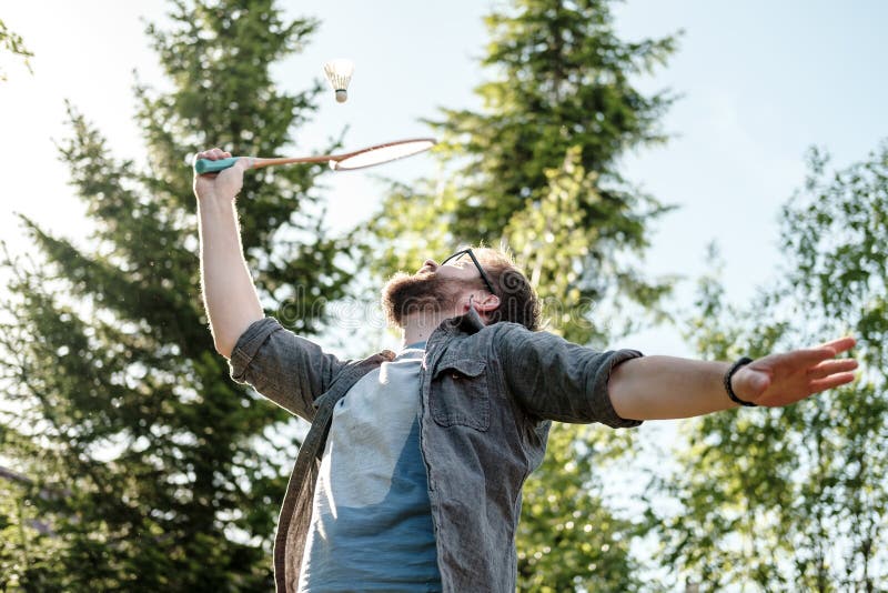Jeune homme jouant l'extérieur de badminton en parc Concept d'un mode de vie actif et sain photo libre de droits