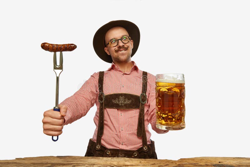 Happy. Young smiling man in hat, wearing fest traditional German costume with huge glass of beer isolated on white background. Concept of alcohol, traditions, holidays, Oktoberfest. Copy space for ad. Happy. Young smiling man in hat, wearing fest traditional German costume with huge glass of beer isolated on white background. Concept of alcohol, traditions, holidays, Oktoberfest. Copy space for ad