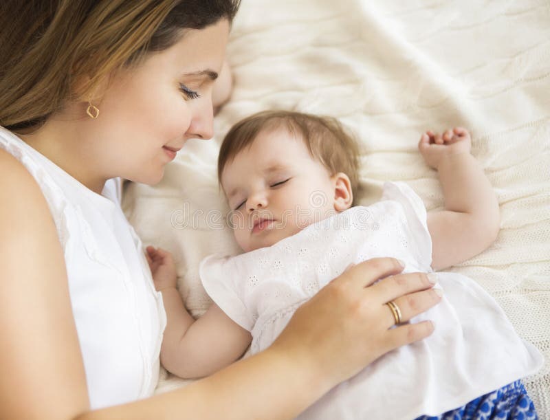 Jeune jolie femme avec le bébé de sommeil photos stock Jeune jolie femme avec le bébé de sommeil photos stock