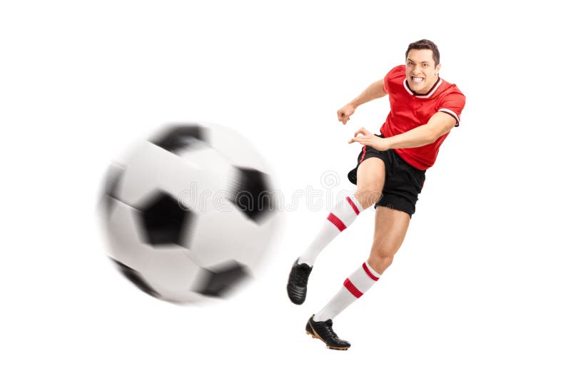 Jeune joueur de football donnant un coup de pied une boule dur image libre de droits Jeune joueur de football donnant un coup de pied une boule dur image libre de droits