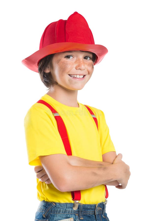 Closeup of smiling boy wearing firefighter helmet isolated on white background. Happy little fireman looking at camera with armcrossed. Closeup of smiling boy wearing firefighter helmet isolated on white background. Happy little fireman looking at camera with armcrossed.