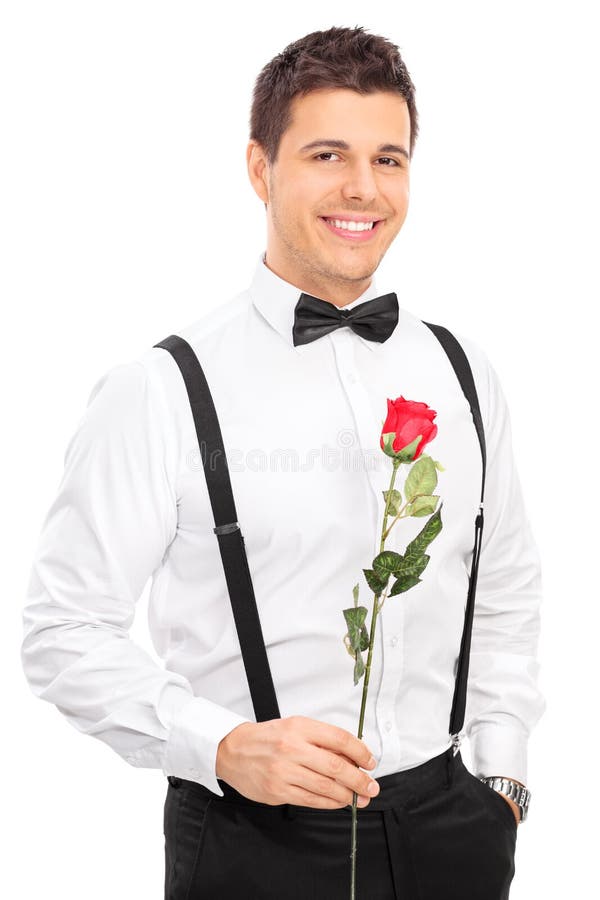 Jeune type romantique tenant une rose rouge photo stock Jeune type romantique tenant une rose rouge photo stock