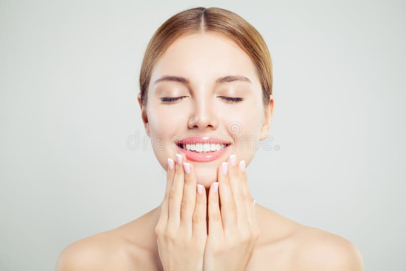 Jeune visage parfait de femme avec les lèvres brillantes roses et les mains manicured avec des ongles de manucure française photographie stock libre de droits Jeune visage parfait de femme avec les lèvres brillantes roses et les mains manicured avec des ongles de manucure française photographie stock libre de droits