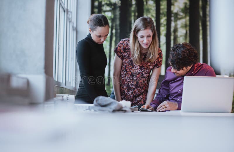 Jeune équipe d'affaires travaillant ensemble sur une idée créative photographie stock libre de droits Jeune équipe d'affaires travaillant ensemble sur une idée créative photographie stock libre de droits