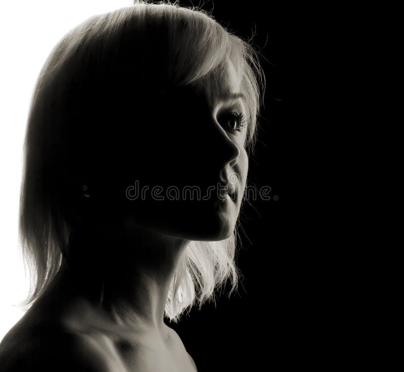 Young woman fine-art high-contrast portrait in backlight. Young woman fine-art high-contrast portrait in backlight