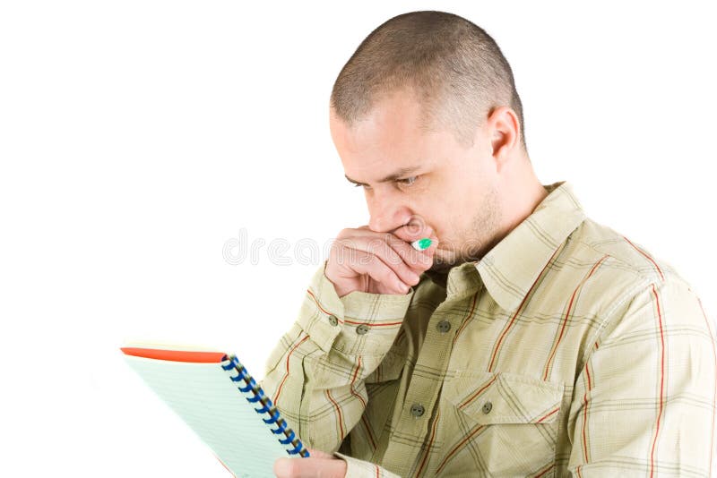 Young casual businessman writing in a notebook. Young casual businessman writing in a notebook