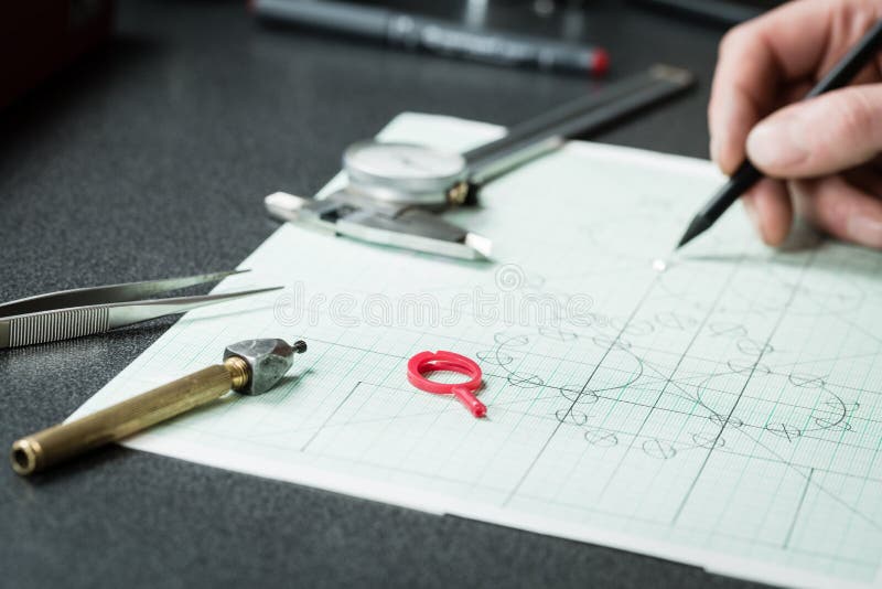 Jewelry designer works on a hand drawing sketc