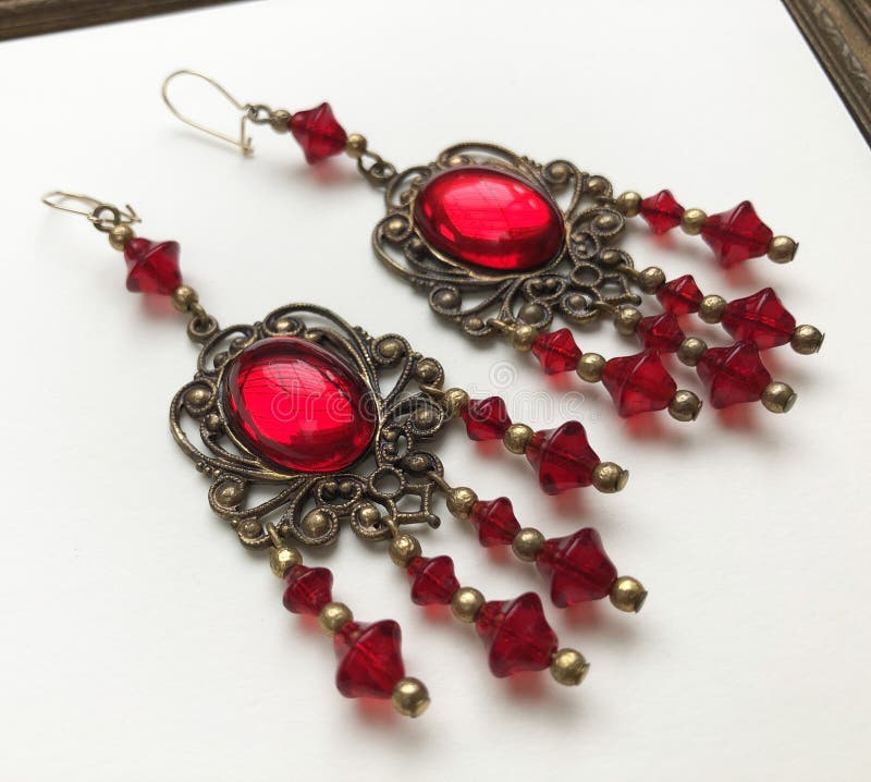 jewelry earrings with red ruby on a white background.