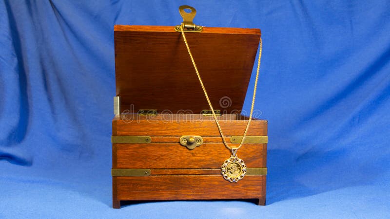 Jewerly pendant that was made using gold sovereign coin on wooden present box stock image Jewerly pendant that was made using gold sovereign coin on wooden present box stock image