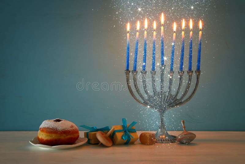 jewish holiday Hanukkah background with traditional spinnig top, menorah & x28;traditional candelabra& x29; and burning candles