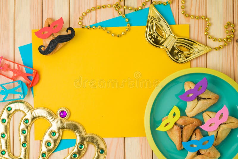 Jewish holiday Purim background with cute funny hamantaschen cookies and paper note on wooden table royalty free stock photo Jewish holiday Purim background with cute funny hamantaschen cookies and paper note on wooden table royalty free stock photo