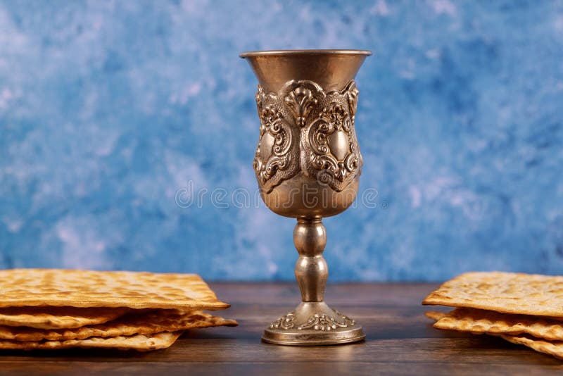 Jewish silver cup with wine with matzos. Passover concept