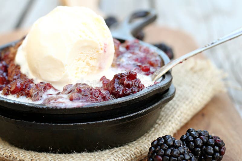 Blackberry cobbler served in cast iron skillet. Blackberry cobbler served in cast iron skillet.