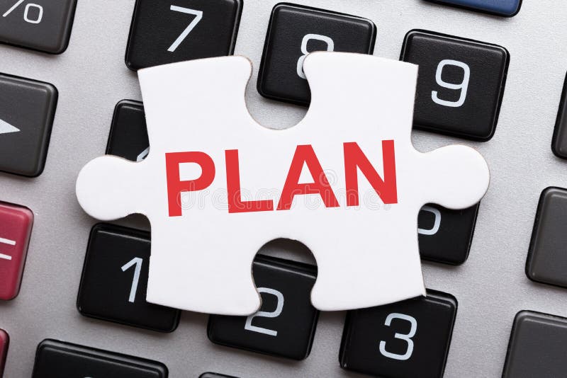 Jigsaw Puzzle Piece With Plan Text On Calculator royalty free stock image