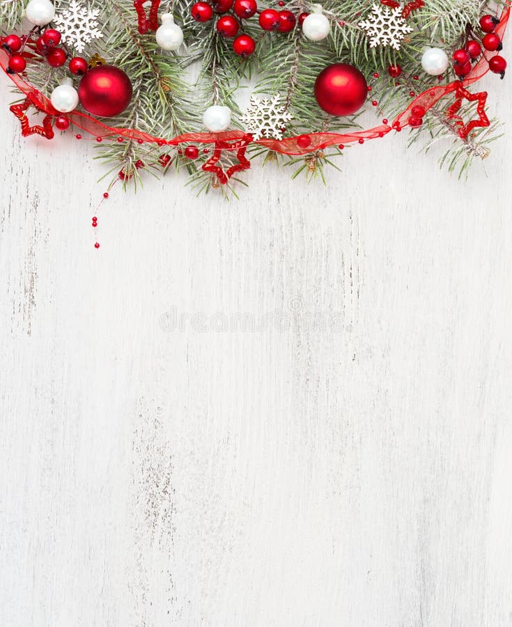 Fir branch with Christmas decorations on old wooden shabby background with empty space for text. Top view. Fir branch with Christmas decorations on old wooden shabby background with empty space for text. Top view.