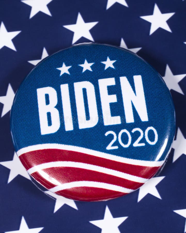 London, UK - February 10th 2020: A Joe Biden 2020 pin badge pictured over the USA flag symbolizing his campaign to become the next President of the United States. London, UK - February 10th 2020: A Joe Biden 2020 pin badge pictured over the USA flag symbolizing his campaign to become the next President of the United States
