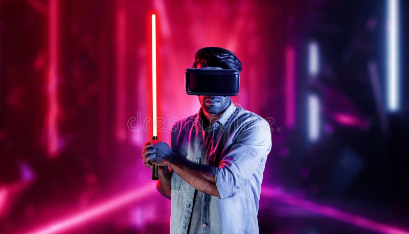 Gamer holding laser sword and playing action game while wearing VR glasses. Caucasian man using visual reality headset while standing and surrounding by neon castle. Innovation technology. Deviation. Gamer holding laser sword and playing action game while wearing VR glasses. Caucasian man using visual reality headset while standing and surrounding by neon castle. Innovation technology. Deviation.