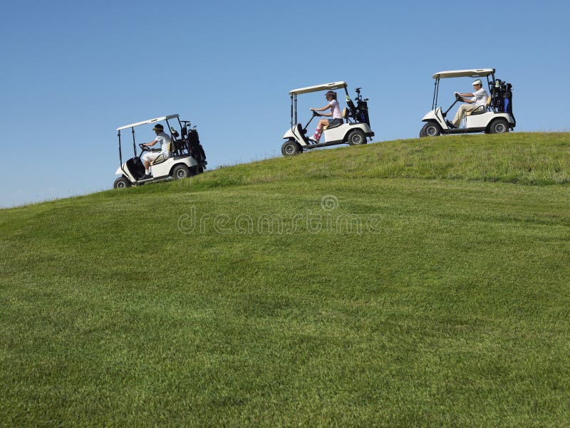 Jogadores de golfe que conduzem carros foto de stock Jogadores de golfe que conduzem carros foto de stock
