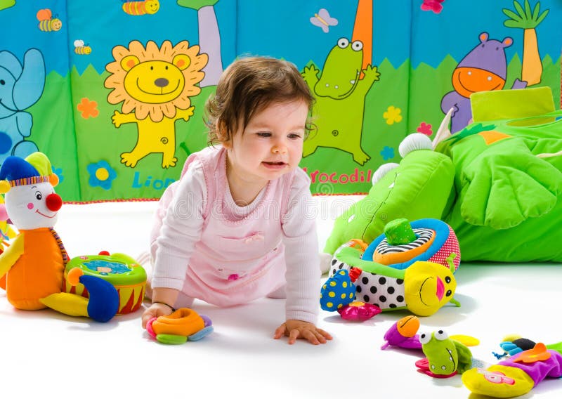 Happy baby playing with soft toys, smiling, isolated on white background. Happy baby playing with soft toys, smiling, isolated on white background.
