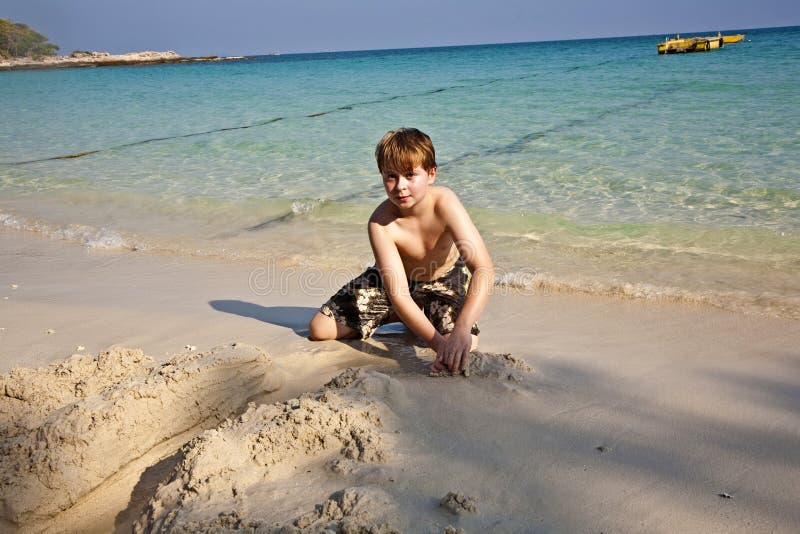 Jogos Dos Meninos Na Praia Com Areia Foto de Stock - Imagem de