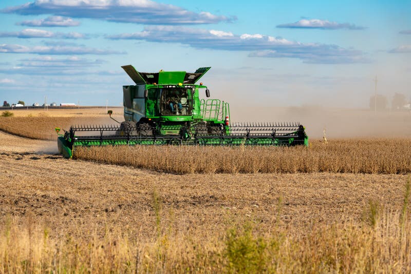 A John Deere Combine harvester clearing a soybean field