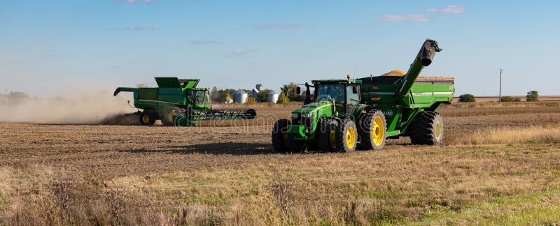 A John Deere combine harvesting soybean