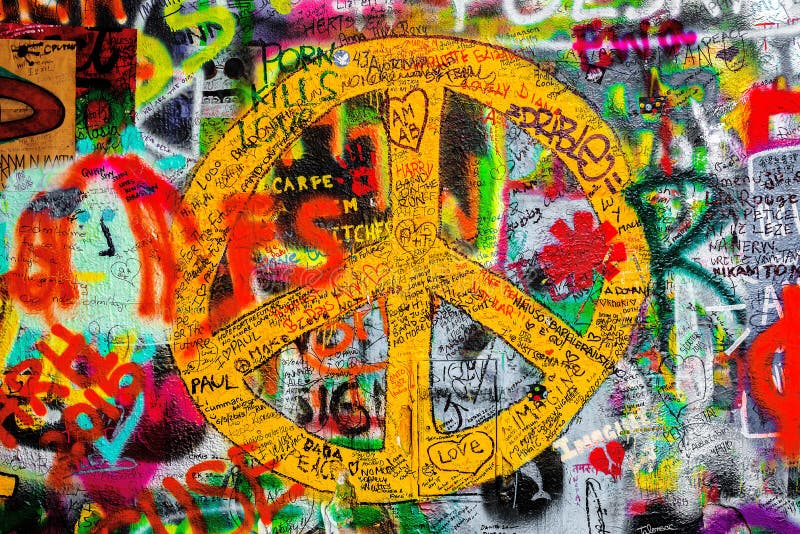 PRAGUE, CZECH REPUBLIC - MAY 21, 2015: Peace Sign on Famous John Lennon Wall on Kampa Island in Prague filled with Beatles inspired graffiti and lyrics since the 1980s. PRAGUE, CZECH REPUBLIC - MAY 21, 2015: Peace Sign on Famous John Lennon Wall on Kampa Island in Prague filled with Beatles inspired graffiti and lyrics since the 1980s.